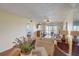 Cozy living room with comfortable couches, a ceiling fan, and a view of the lanai at 8711 Blind Pass Rd # 307A, St Pete Beach, FL 33706
