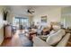 Bright living room with water views, comfy seating, and hardwood floors at 8711 Blind Pass Rd # 307A, St Pete Beach, FL 33706