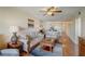 Warm and inviting living room featuring wood floors, comfortable seating, and an open floor plan to the dining area at 8711 Blind Pass Rd # 307A, St Pete Beach, FL 33706