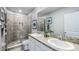Bathroom with double vanity, granite countertop, and a large shower at 11385 Crescent Deer Dr, Land O Lakes, FL 34638