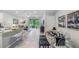Open concept dining area with modern glass table and bench seating at 11385 Crescent Deer Dr, Land O Lakes, FL 34638