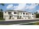 Modern three-story townhome with attached garages and neutral color palette at 11385 Crescent Deer Dr, Land O Lakes, FL 34638