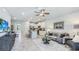 Open concept living room with kitchen view and neutral decor at 11385 Crescent Deer Dr, Land O Lakes, FL 34638