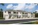 New townhome community with multiple units, featuring attached garages and neutral color palettes at 11389 Crescent Deer Dr, Land O Lakes, FL 34638