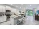 Modern kitchen with stainless steel appliances, an island, and white shaker cabinets at 11389 Crescent Deer Dr, Land O Lakes, FL 34638