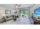 Bright and airy living room with a neutral color palette and access to a patio at 11389 Crescent Deer Dr, Land O Lakes, FL 34638