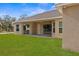 House with covered patio and spacious grassy backyard at 13254 Kitty Rd, Weeki Wachee, FL 34614