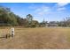 Large grassy backyard with chain link fence and well at 13254 Kitty Rd, Weeki Wachee, FL 34614