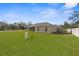 Large grassy backyard with a privacy fence at 13254 Kitty Rd, Weeki Wachee, FL 34614