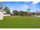 Spacious grassy backyard with trees and privacy fence at 13254 Kitty Rd, Weeki Wachee, FL 34614