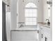Spa-like bathroom with soaking tub, white tile, and a large window at 13254 Kitty Rd, Weeki Wachee, FL 34614