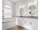 Elegant bathroom featuring double vanity, soaking tub, and large mirrors at 13254 Kitty Rd, Weeki Wachee, FL 34614