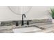 Modern bathroom sink with black matte faucet and granite countertop at 13254 Kitty Rd, Weeki Wachee, FL 34614