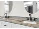 Double vanity bathroom sink with black matte faucets and granite countertop at 13254 Kitty Rd, Weeki Wachee, FL 34614