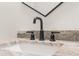 Modern bathroom sink with black matte faucet and granite countertop at 13254 Kitty Rd, Weeki Wachee, FL 34614