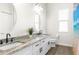 Bathroom with double vanity, granite countertop, and walk-in shower at 13254 Kitty Rd, Weeki Wachee, FL 34614