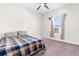 Spacious bedroom with a plaid comforter and large window at 13254 Kitty Rd, Weeki Wachee, FL 34614