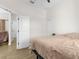 Bedroom with a tan comforter and access to another room at 13254 Kitty Rd, Weeki Wachee, FL 34614