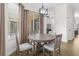 Bright dining area with round table and four chairs, near sliding glass doors at 13254 Kitty Rd, Weeki Wachee, FL 34614