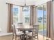 Dining area with round table and four chairs, plenty of natural light at 13254 Kitty Rd, Weeki Wachee, FL 34614