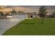 Single-story house with a two-car garage and a large front yard at 13254 Kitty Rd, Weeki Wachee, FL 34614