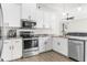 Modern kitchen with white cabinets and stainless steel appliances at 13254 Kitty Rd, Weeki Wachee, FL 34614