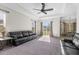 Living room with two black leather sofas and access to the backyard at 13254 Kitty Rd, Weeki Wachee, FL 34614