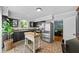 Modern kitchen with dark cabinetry, butcher block island, and mosaic tile floor at 1507 Greenwood N Ave, St Petersburg, FL 33704