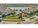 Single-Gathering home on a corner lot with a lake view and lush landscaping at 16340 Treasure Point Dr, Wimauma, FL 33598