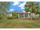 Charming home with a screened patio and tropical landscaping at 16340 Treasure Point Dr, Wimauma, FL 33598