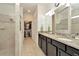Bathroom with double vanity and walk-in shower at 16340 Treasure Point Dr, Wimauma, FL 33598