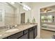 Bathroom with double vanity and view into bedroom at 16340 Treasure Point Dr, Wimauma, FL 33598