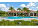 Inviting pool with a clubhouse in the background at 16340 Treasure Point Dr, Wimauma, FL 33598