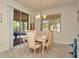Bright dining room with glass-top table and chairs at 16340 Treasure Point Dr, Wimauma, FL 33598