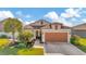 Single-Gathering home with a two-car garage and palm trees in the front yard at 16340 Treasure Point Dr, Wimauma, FL 33598