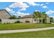 House's side view showcasing a fenced backyard and landscaping at 16340 Treasure Point Dr, Wimauma, FL 33598