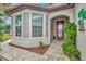 Inviting front entry with a decorative door and a paved walkway at 16340 Treasure Point Dr, Wimauma, FL 33598