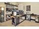 Spacious home office features a large desk, dual monitors, and ample storage at 16340 Treasure Point Dr, Wimauma, FL 33598