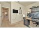 Bright home office with built-in shelving and views into a hallway at 16340 Treasure Point Dr, Wimauma, FL 33598