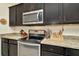 Modern kitchen features granite countertops and stainless steel appliances at 16340 Treasure Point Dr, Wimauma, FL 33598
