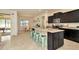 Open kitchen with island, granite countertops, and stainless steel appliances at 16340 Treasure Point Dr, Wimauma, FL 33598