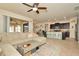 Open living room and kitchen with an island and stainless steel appliances at 16340 Treasure Point Dr, Wimauma, FL 33598