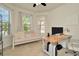 Home office featuring a built-in desk, comfortable seating and large windows at 16340 Treasure Point Dr, Wimauma, FL 33598