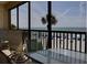 Balcony with table and chairs overlooking the beach at 20040 Gulf Blvd # 302, Indian Shores, FL 33785