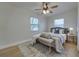 Cozy bedroom with light walls, wood floors and ceiling fan at 2942 24Th N Ave, St Petersburg, FL 33713