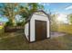 White shed with brown doors in the backyard at 2942 24Th N Ave, St Petersburg, FL 33713