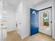 Bright entryway with blue door and view of the bathroom at 29727 67Th N St, Clearwater, FL 33761