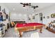 Spacious game room with a pool table and a seating area at 31014 Kelmin Ter, Wesley Chapel, FL 33543