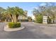 Gated community entrance with lush landscaping and palm trees at 3117 Bayshore Oaks Dr, Tampa, FL 33611