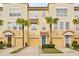 Three-story townhouses with attached garages and lush landscaping at 3117 Bayshore Oaks Dr, Tampa, FL 33611